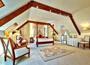 a large room with a bedroom with a bed and a couch at Manoir De Kertalg in Moëlan-sur-Mer +93 photos
