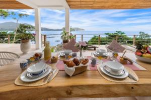 a table with food and a view of the ocean at Hortensia Luxury Beach Villa in Chaloklum