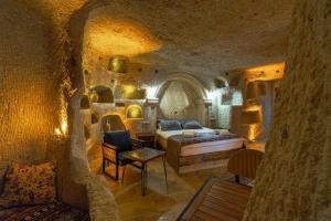 a bedroom with a bed in a stone room at Tyana Cave House in Nar