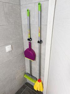 two mops and mitts on the wall of a shower at Stella's House Mangana in Mángana +22 photos