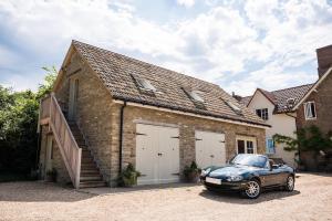 a car parked in front of a brick garage at The Loft in Calne