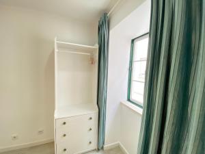 a bedroom with a dresser and a window at Vibrant Setúbal II, By Home Match in Setúbal