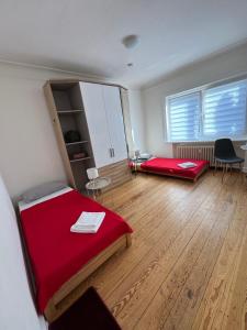a room with two beds and a red blanket at City Quartier Wedel in Wedel