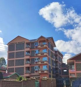 a large apartment building in front of a blue sky at Nyeri 1 Bedroom BnB in Nyeri