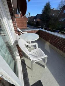 a white table and two chairs on a balcony at City Quartier Wedel in Wedel