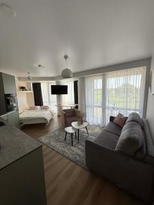 a living room with a couch and a table at Breeze Studio in Palanga