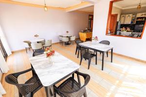 a dining room with a table and chairs at EL ROi KADOSHI MOTEL in Kyenjojo