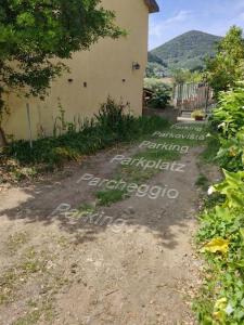 a path to a house with writing on it at Angolo Azzurro in Asciano Pisano