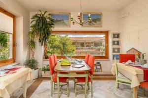 a dining room with a table and chairs and a window at sopra al FORTE in Querceta