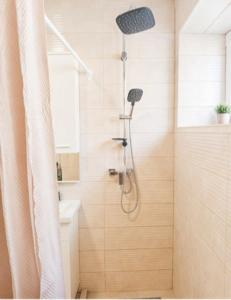 a bathroom with a shower with a shower head at Stan na dan ,, Vidovdan ,, in Nevesinje