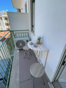 a small balcony with a table and two chairs at Casa GIGIA in Sperlonga