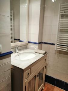 a bathroom with a sink and a mirror at Apartamentos Casa Memé in Mora de Rubielos +52 photos