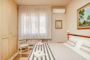 a bedroom with a bed and a window at sopra al FORTE in Querceta