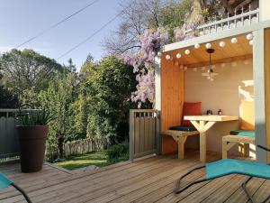 a patio with a table and chairs on a deck at Gîte classé 3 étoiles - Morlaix in Morlaix