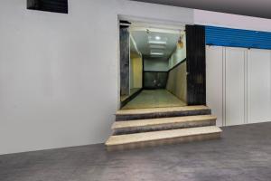a hallway with stairs in an office building at Super Hotel O MG Road Raniganj Formerly Holiday Hotel in Hyderabad