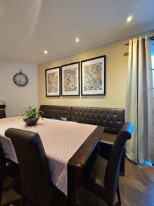 a dining room with a table and chairs at Die Haas-Villa in Berg +4 photos