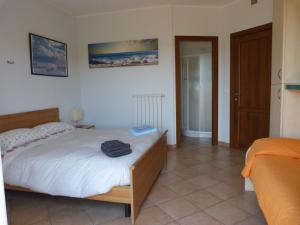 a bedroom with a large bed with at La Testa Fra Le Nuvole in Finale Ligure