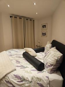 a bed with a comforter and pillows on it at Die Haas-Villa in Berg
