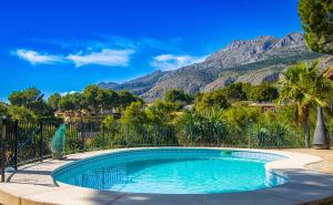 a swimming pool with a mountain in the background at Casa Les Fremeaux in Altea