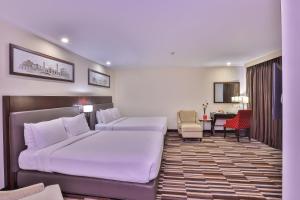 a hotel room with a bed and a dining room at Avari Xpress Gulberg in Lahore +71 photos