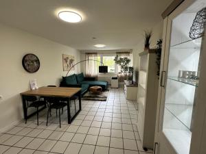 a kitchen and living room with a table and a couch at Hostel by BookieBooking in Wiesbaden