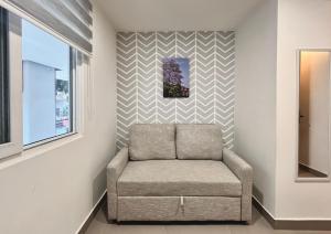 a chair in a room with a striped accent wall at Reset (Hotel-Cafe-Coworking) in Cali