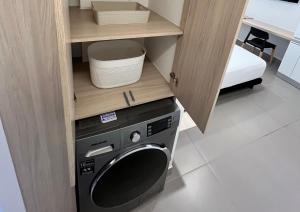 a small kitchen with a washing machine in a cabinet at Reset (Hotel-Cafe-Coworking) in Cali
