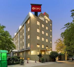 a building with a clock on top of it at OPO Horizon LYRO Hotel , Formerly known as Inde Hotel in Gurgaon