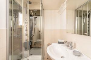a bathroom with a sink and a shower at sopra al FORTE in Querceta +26 photos
