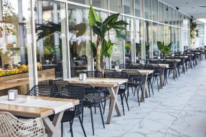 a row of tables and chairs in a restaurant at Hotel Bavaro in Sunny Beach