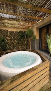 a hot tub in the middle of a patio at Dalikyda - La Bulle - Loveroom in Le Havre