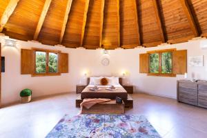 a bedroom with a bed in a room with wooden ceilings at Pinnettu Sa Rosa - Jacuzzi & Relax Deluxe in Quartu SantʼElena