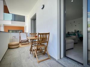 a room with two chairs and a table on a balcony at Apt IM - With pool, wifi and parking in Pêra