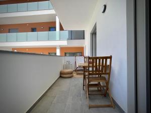 a hallway with chairs and a table in a building at Apt IM - With pool, wifi and parking in Pêra