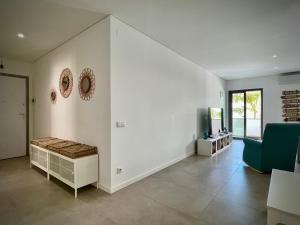 a living room with a couch and a table at Apt IM - With pool, wifi and parking in Pêra +25 photos