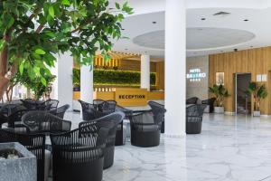 a lobby with chairs and tables in a building at Hotel Bavaro in Sunny Beach +90 photos