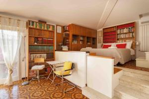 a bedroom with a bed and bookshelves at sopra al FORTE in Querceta
