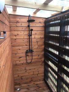 a wooden wall with a light fixture on it at Saare-Toominga camping house in Väike-Rakke +20 photos