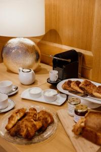 a table topped with pastries and pastries on plates at Domaine de Thironne Lac & Nature in Montigny-le-Chartif