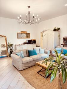 a living room with a couch and a chandelier at Palazzo Spasiano rooms - SORRENTO CENTER in Sorrento
