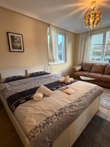a bedroom with a large bed and a couch at The Cozy House in Kyustendil