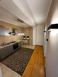 a large kitchen with a table and a refrigerator at Zimmervermietung Linz 1 in Linz