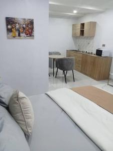 a living room with a couch and a kitchen at PrimeAxishub in Ilorin