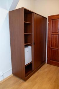 a large wooden book shelf in a room with a door at Penzion Navara in Kolín +26 photos
