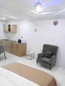 a living room with a couch and a chair at PrimeAxishub in Ilorin