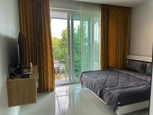 a bedroom with a bed and a large window at Villa Worawan Pool Villa Bo Phut in Nathon Bay +94 photos