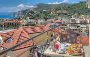 a table with a plate of food on a balcony at Hotel Noris in Finale Ligure