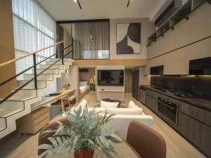 a large living room with a staircase and a table at Luxury 2br Apt & Pool access in Panama City