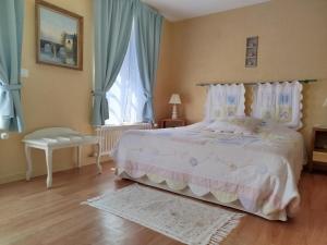 a bedroom with a large bed and a window at Béthanie in Firfol