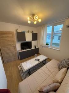 a living room with a couch and a table at The Cozy House in Kyustendil